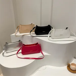 Minimalist rectangular shoulder bags in five colors on geometric display stands