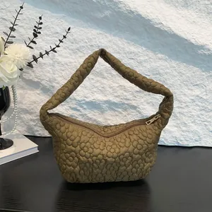 Olive green quilted floral shoulder bag with puff texture and crescent shape design