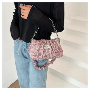Detail of dusty rose pleated cloud bag with silver chain strap and fabric handle
