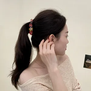 Banana hair clip with colorful resin flowers and rhinestones on ponytail model
