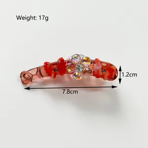 Pince à cheveux banane avec nœud en résine orange et strass pour queue de cheval