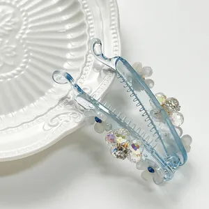 Elegant blue resin banana hair clip with five-petal flowers and colorful crystals