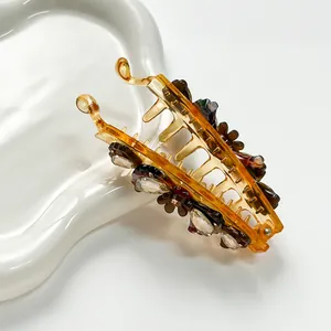 Amber acetate banana clip with crystal flower detail for elegant ponytail hairstyles