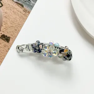 Detail of floral banana clip with marble blue petals and sparkling crystal rhinestones