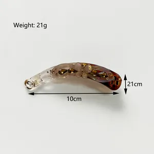 Detail view of 10cm amber banana hair clip with resin flowers and rhinestones