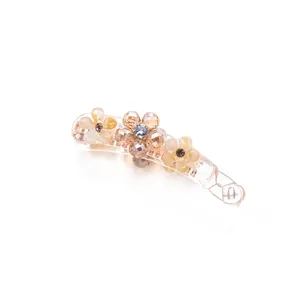 Champagne gold banana hair clip with elegant floral rhinestone design on white background