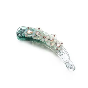 Pince à cheveux banane verte élégante avec nœuds en résine et strass couleur ambre