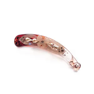Elegant reddish-brown resin banana clip with floral rhinestone details on white backdrop