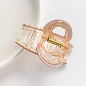 Minimalist translucent peach pink hair claw clip for women's half-up hairstyles