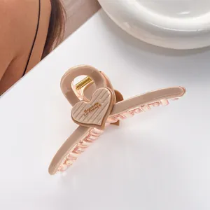 Detailed close-up of glossy pink heart hair claw clip with Barrette La France lettering