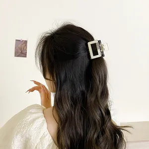 Elegant cream white square hair claw clip with rhinestones worn on wavy brown hair