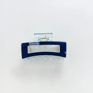Detail of blue acrylic hair claw clip with twelve sparkling rhinestone embellishments