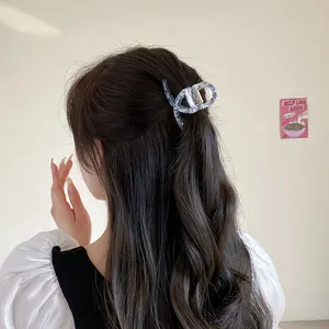 Elegant blue marble acetate hair claw clip for women's half-up hairstyles with secure grip