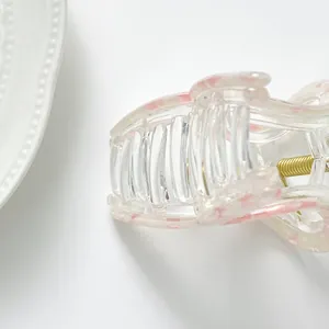 Close-up of pink floral acrylic mini hair claw clip with a durable metal spring
