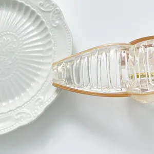 Close-up of extra-large clear hair claw clip with gold spring and amber edges