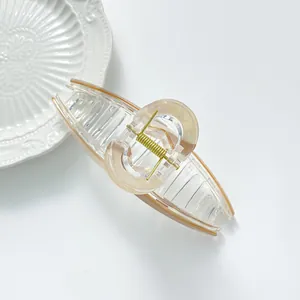 Extra large hair claw clip with amber marble resin rings and gold metal spring
