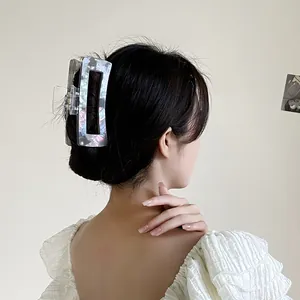 Large square acetate claw clip with pearlescent texture on long black hair for women