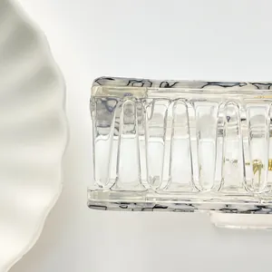 Close-up of a large transparent square hair claw clip with black speckled texture patterns