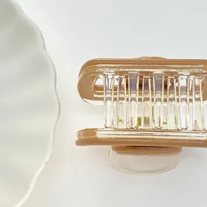 Detail view of caramel acrylic hair claw clip with strong metal spring and teeth