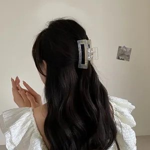 Chic iridescent square hair claw clip in blue and amber marble for half-up hairstyles