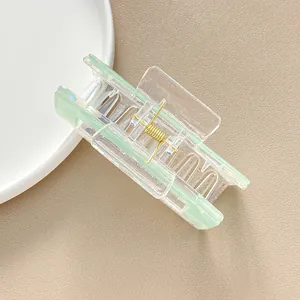 Iridescent square hair claw clip in gradient light green and transparent acrylic material