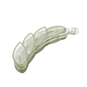 Leaf-shaped banana hair clip with iridescent pearlescent finish and green frame