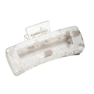 Macro detail of large rectangular marble textured hair claw clip with metal spring