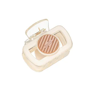 Elegant rectangle cream hair claw clip with brown Barrette La France circular disc detail