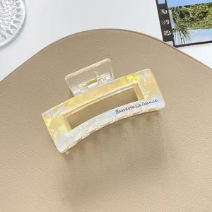 Macro view of pearlescent square hair claw with Barrette La France lettering