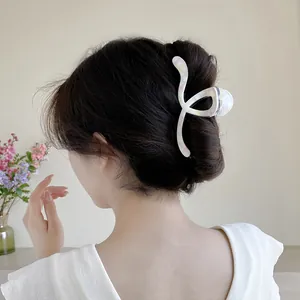 Large 13cm marble texture hair claw clip styled on a model's elegant updo