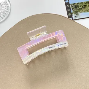 Close-up of pink iridescent square hair claw clip with Barrette La France gold lettering