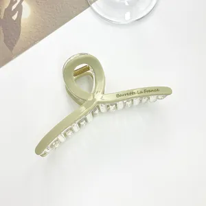 Detailed close-up of large light green hair claw clip with Barrette La France lettering