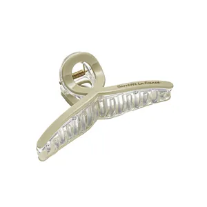 Large beige shark hair clip with La France letter print on white background