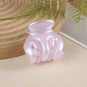 Detail view of a lavender pearl hair claw clip with a glossy finish for high ponytails
