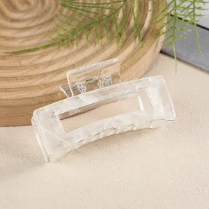 Detail showing marble texture on large rectangular acrylic hair claw with golden spring