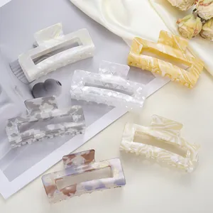 Detailed set of six 8cm acetate hair claws in assorted floral and marble patterns