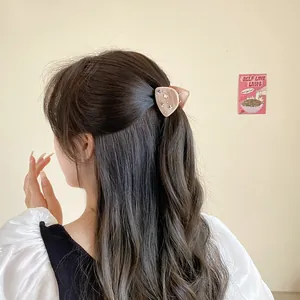 Star patterned triangular hair claw clip in soft pink finish for women's hairstyling