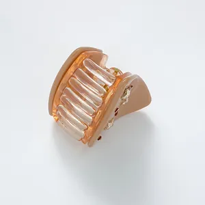 Detail of star-shaped accents on a beige hair claw with a durable metal spring