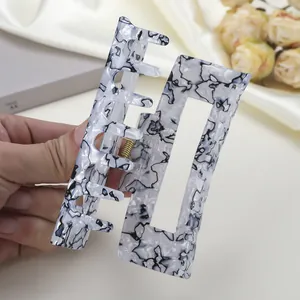 Pince à cheveux rectangulaire à motif marbre noir et blanc avec ressort doré