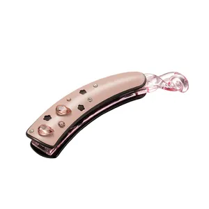 Pince à cheveux banane élégante rose nude avec strass et détails fleuris sur fond blanc