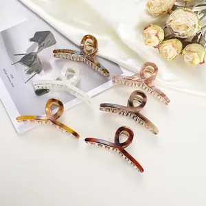 Close-up of assorted tortoiseshell hair claws on silk fabric with dried flowers decoration