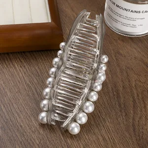 Detail view of large mermaid tail hair claw with gradient resin and pearl accents