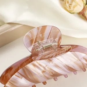 Elegant large leopard print hair claw clip with marble texture and gold metal spring