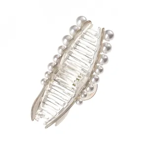Detailed macro view of the elegant pearl hair claw clip with transparent resin and metal spring