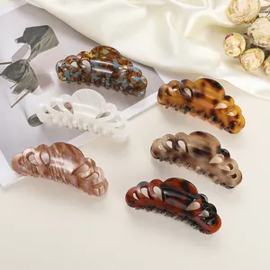 Detail of six acetate hair claws in tortoise shell and marble patterns for women