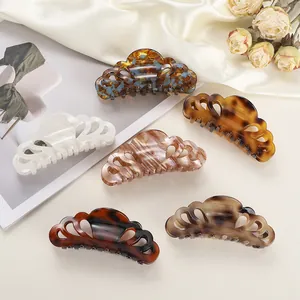 Detail of elegant acetate hair claws featuring vintage tortoiseshell and marble patterns