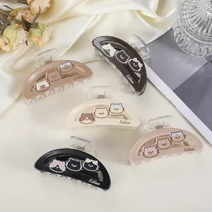 Detailed view of hair claw clips with cute kitten patterns and polished spring mechanism