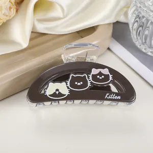Brown shark hair clip featuring cute kitten patterns and text on a silk background