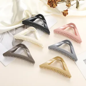 Set of 6 large triangular hair claw clips in assorted matte colors on elegant satin fabric