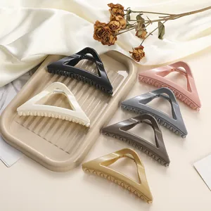 Large triangular hair claws in six colors including cream and black with a glossy finish